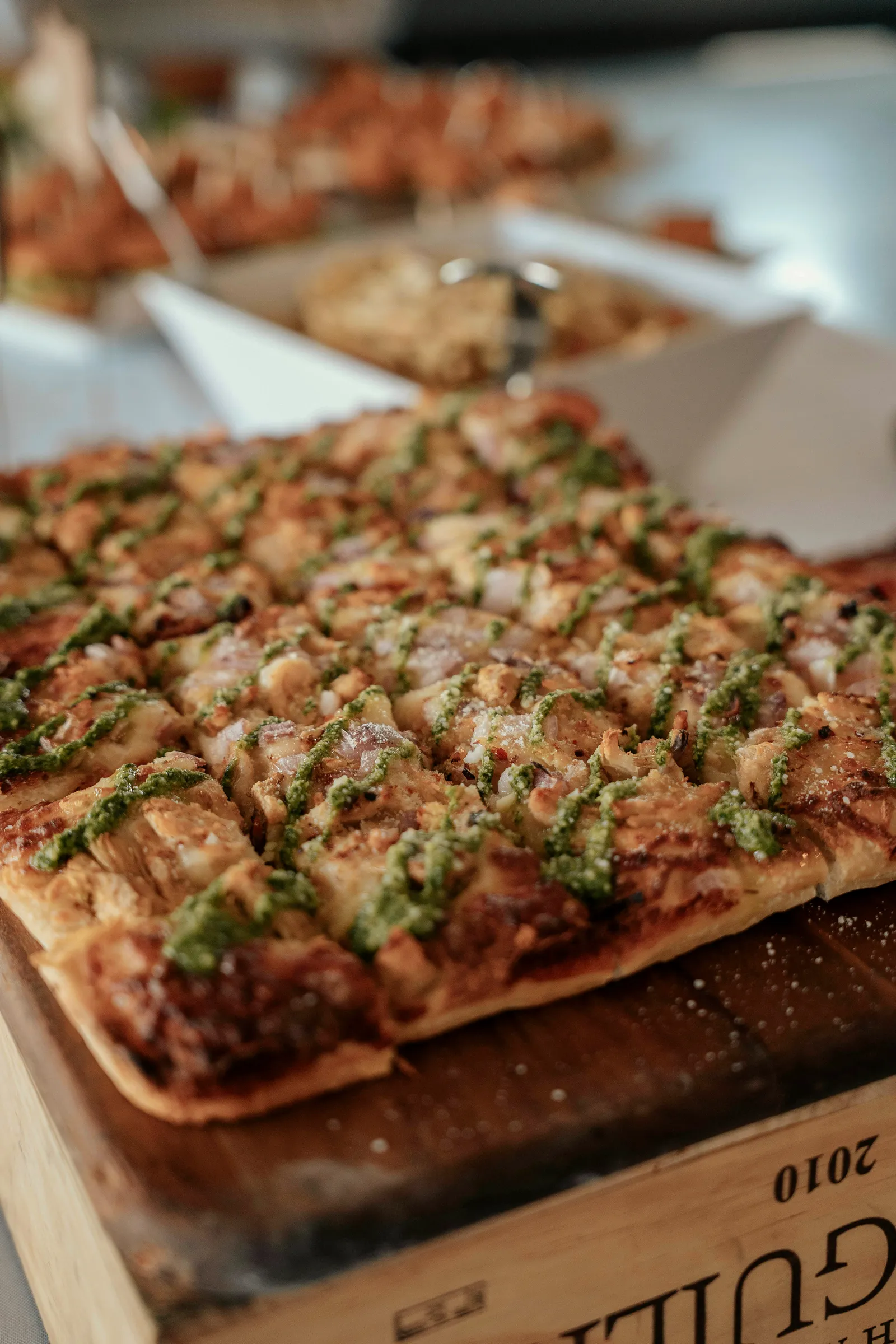 Baldwins Creek Farm - Hopewell Township, NJ: catered chicken pesto flatbread on a wooden board