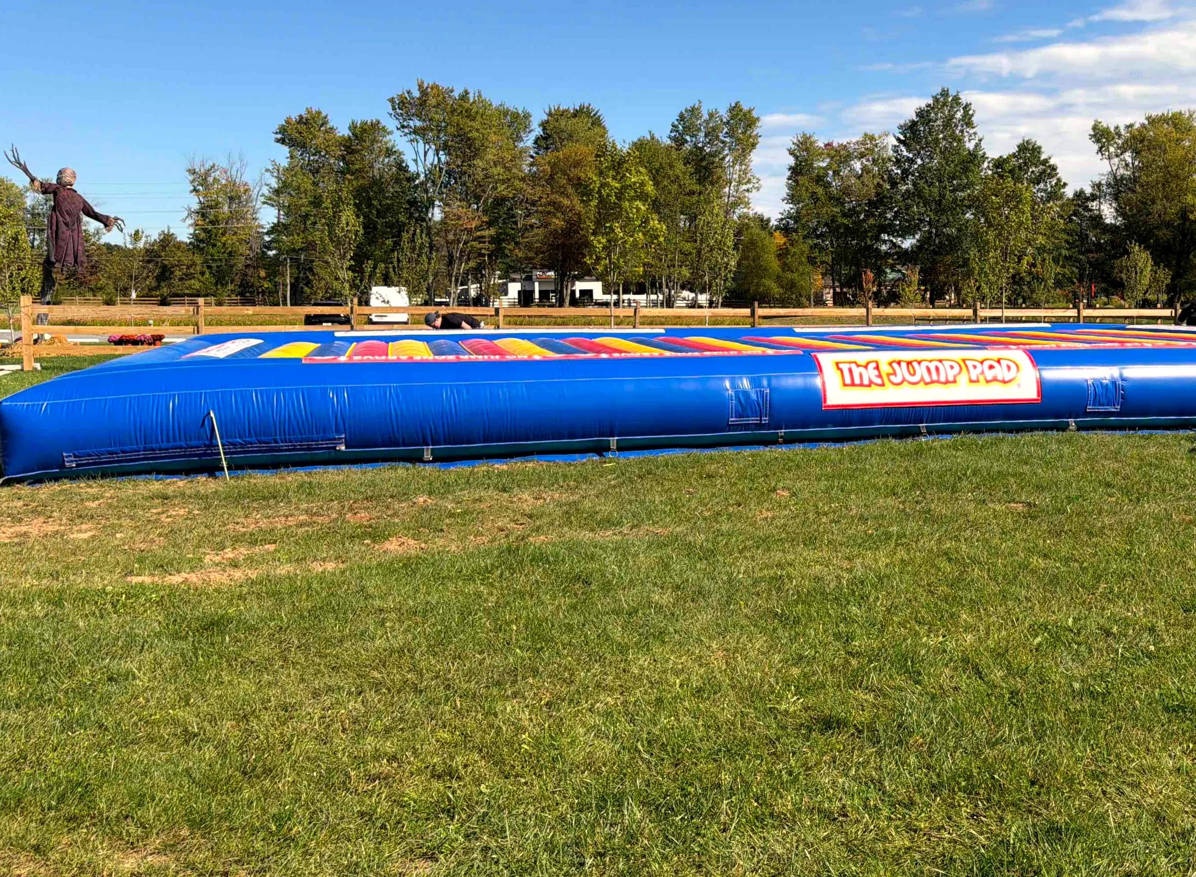 Baldwins Creek Farm - Hopewell Township, NJ: The Jump Pad giant inflatable bounce pad on the festival lawn under a blue fall sky